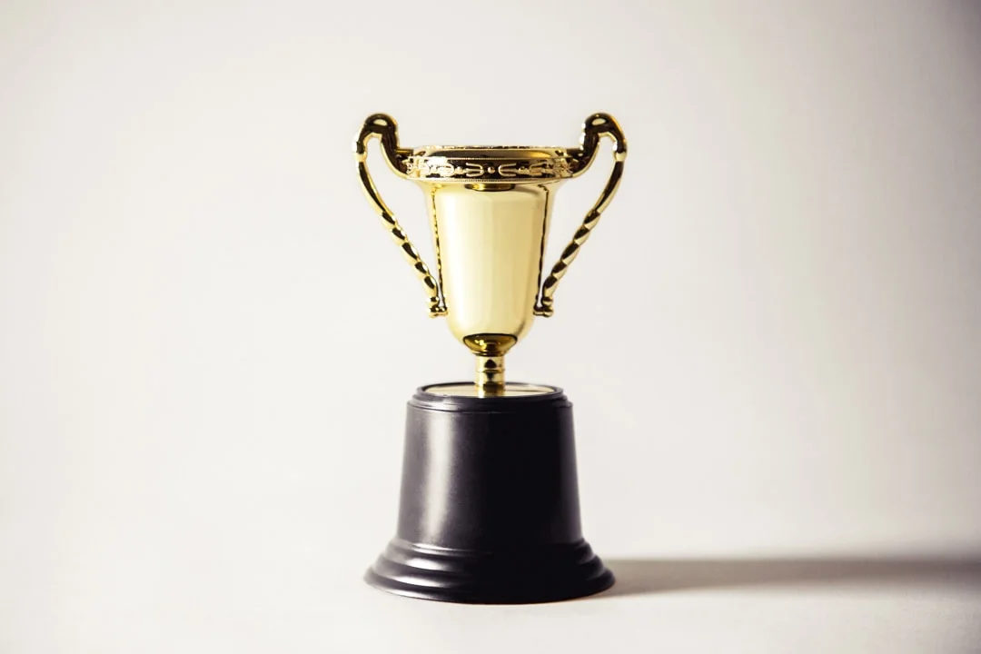 Picture of a gold trophy on plain white background.