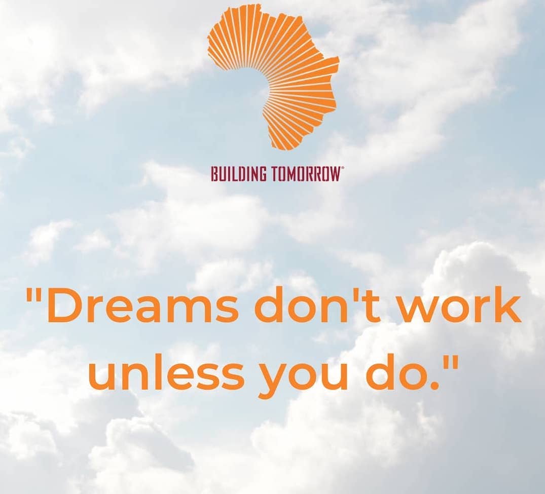 Building Tomorrow logo in front of a cloudy blue sky with the quote "Dreams don't work unless you do." below it.