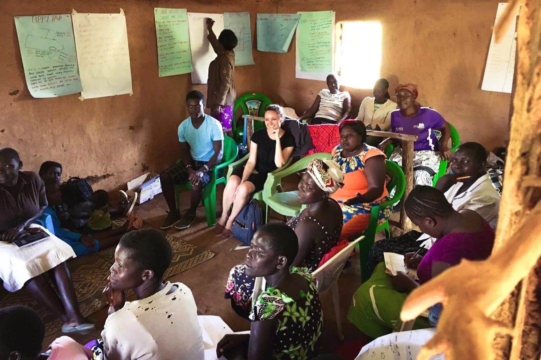 Mighty Ally Co-founder Kathleen Souder sitting in the middle of members from the Lwala Community Alliance in Kenya