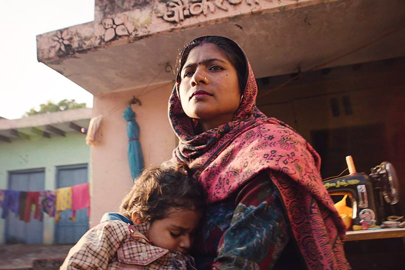 An Indian woman hugging a young Indian girl in a still shot from the film Period: end of sentence.