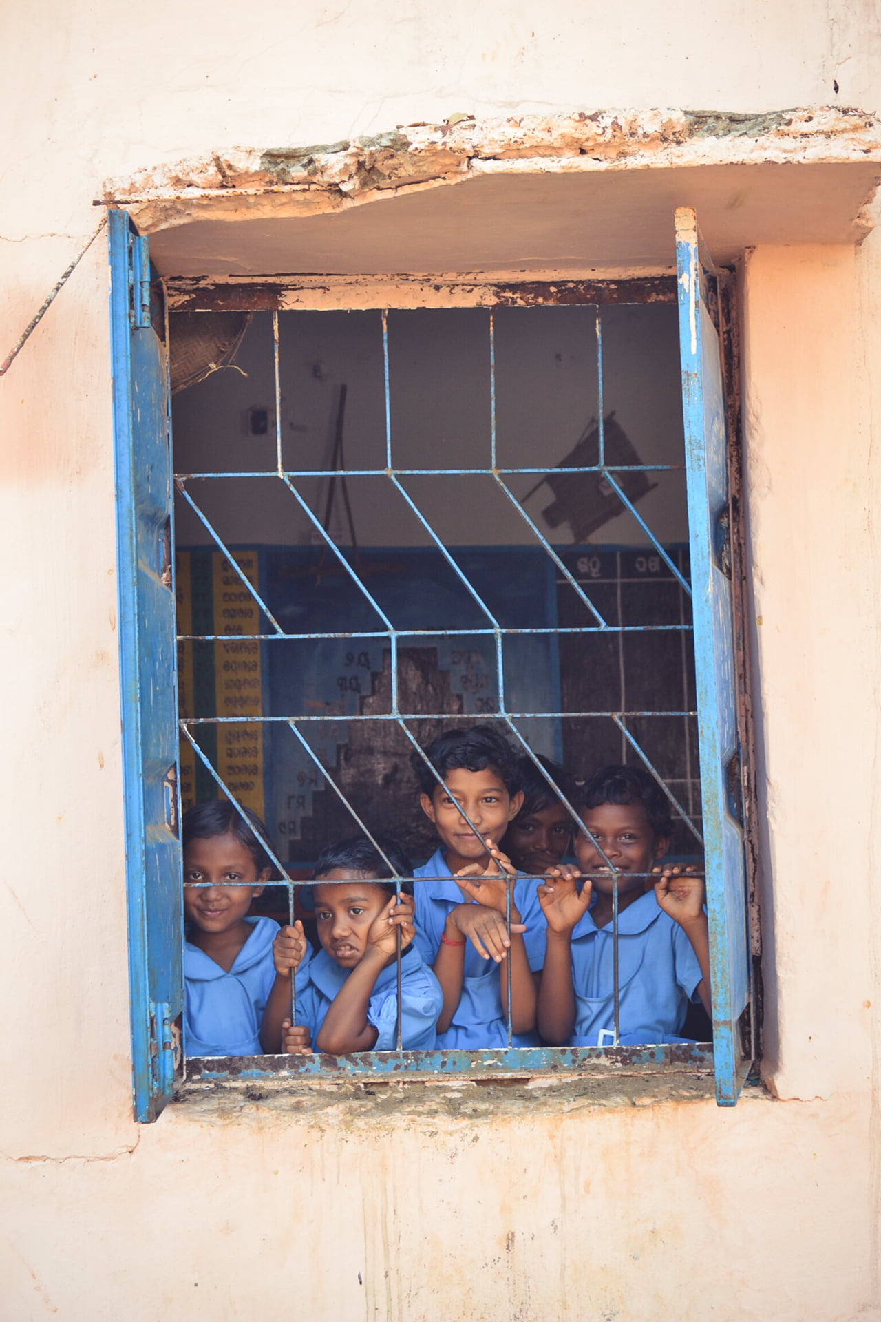 Photo of school children in uniforms, looking through a window, Sabre Education