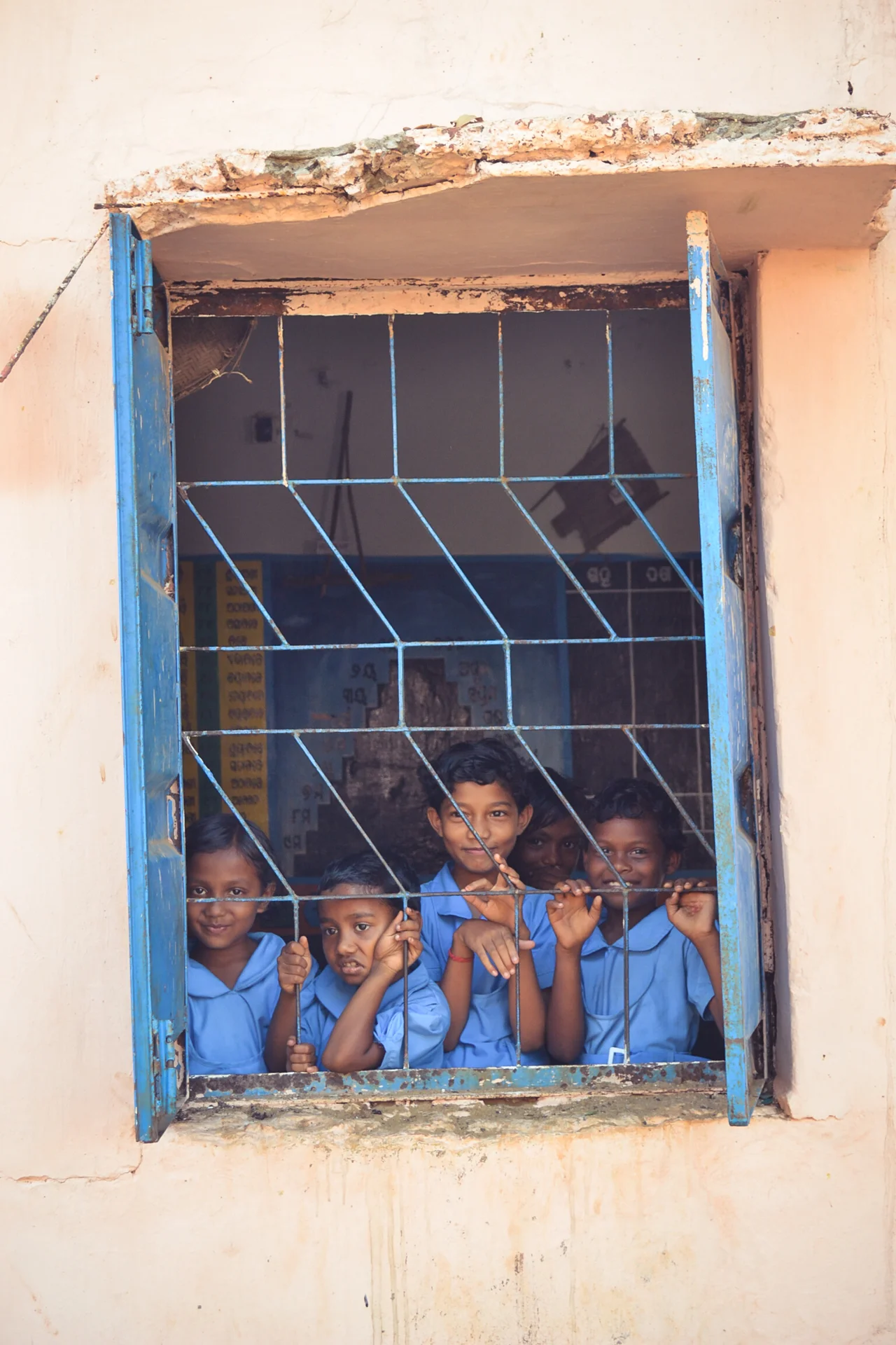 Photo of school children in uniforms, looking through a window, Sabre Education