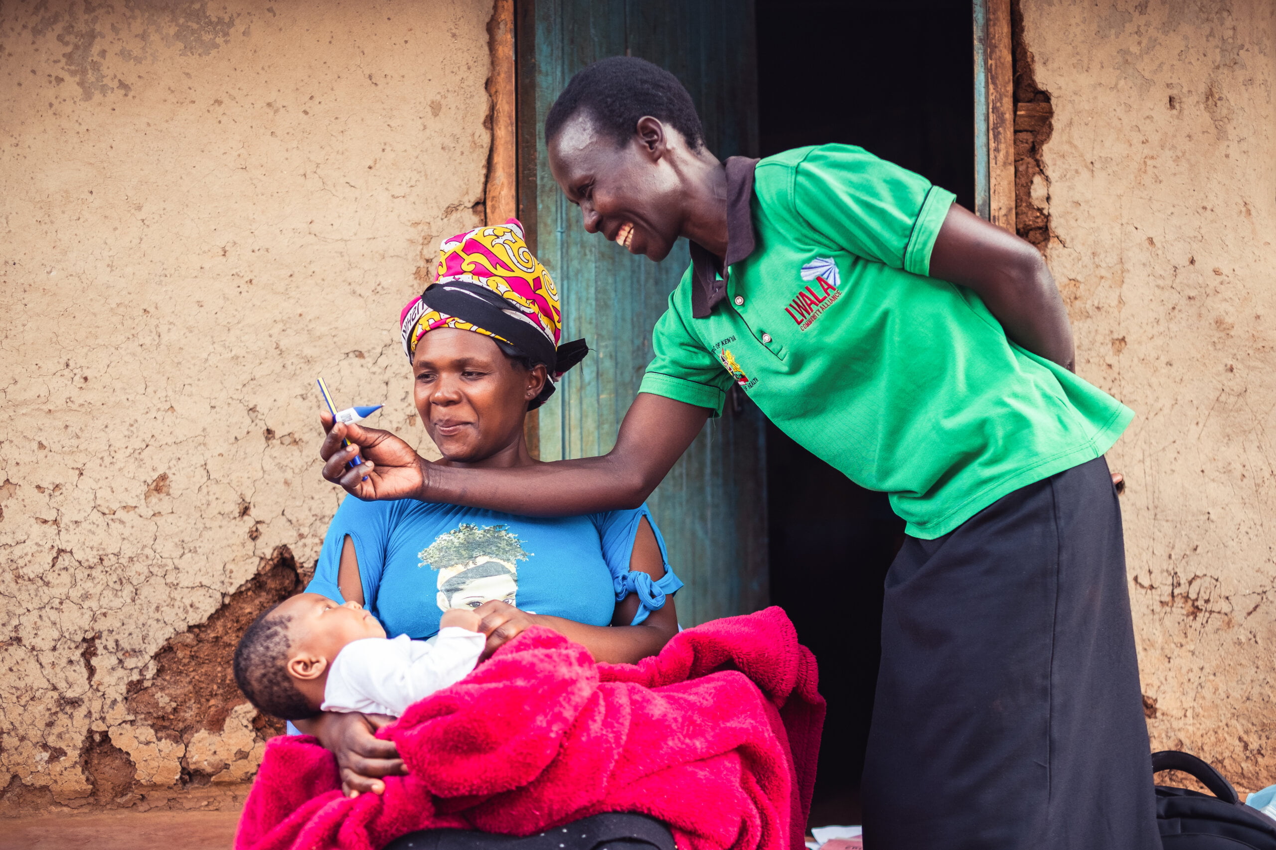 Community health worker from Lwala assisting a new mother and her baby in Kenya