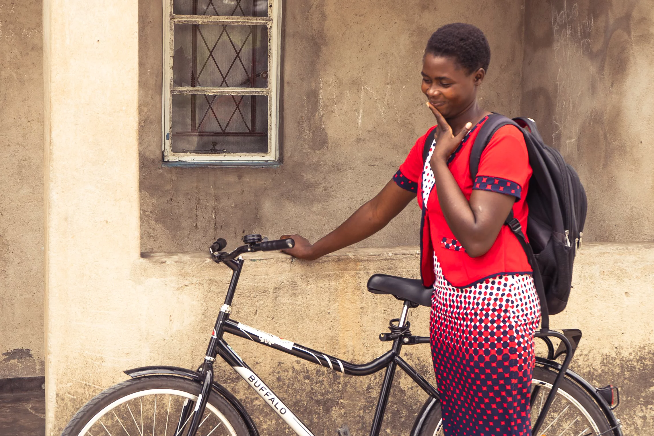 Zvandiri-MIGHTY-ALLY2 African woman standing with her bicycle.