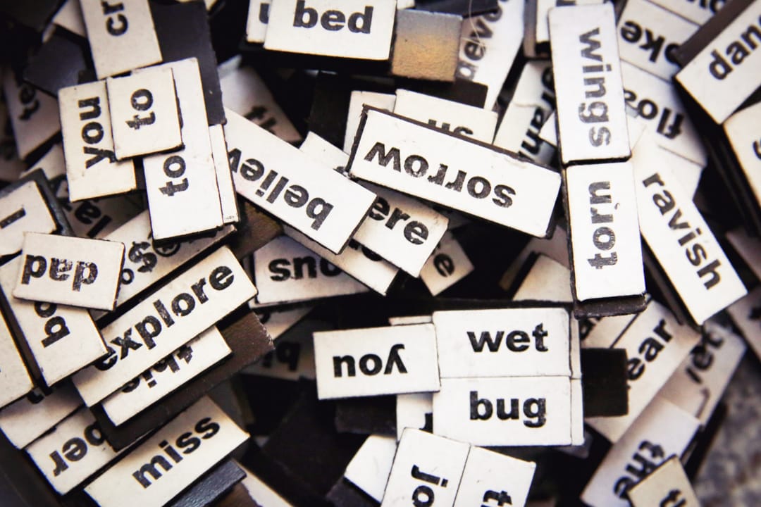 Pile of words typed on small blocks of wood.